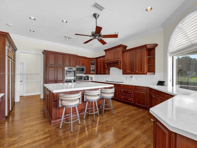 dining space featuring light wood-type flooring, ceiling fan, and crown molding