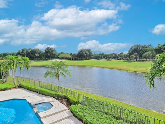 view of swimming pool with an in ground hot tub, a water view, and a lawn