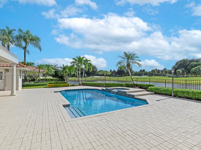 view of swimming pool with an in ground hot tub