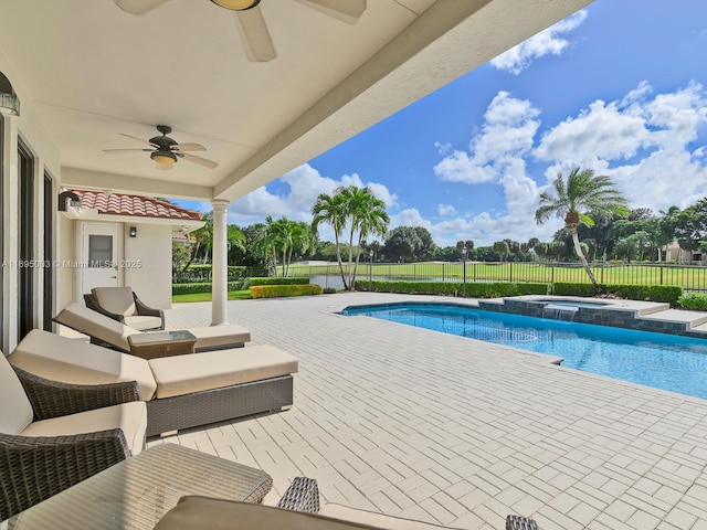 view of swimming pool featuring an in ground hot tub, a patio, and ceiling fan