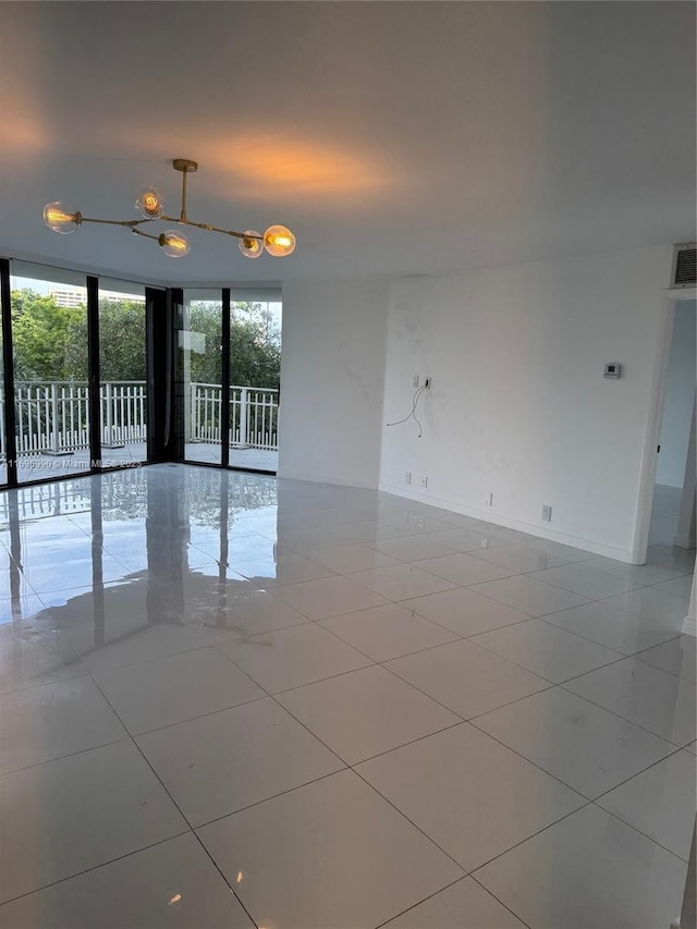 spare room with light tile patterned floors and floor to ceiling windows