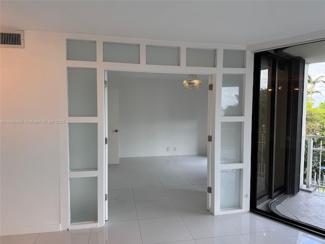 interior space featuring light tile patterned flooring and floor to ceiling windows