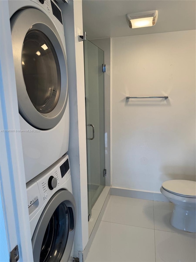 laundry room with light tile patterned floors and stacked washer and clothes dryer