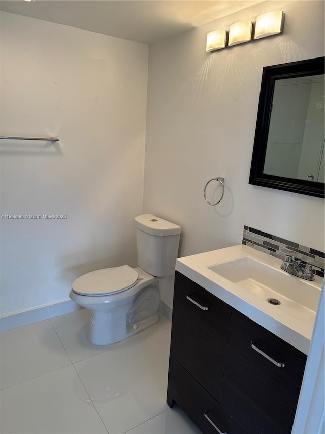 bathroom with decorative backsplash, toilet, vanity, and tile patterned flooring