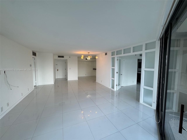 tiled spare room featuring built in features