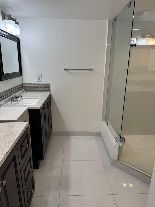 bathroom featuring vanity, tile patterned flooring, and a shower with door