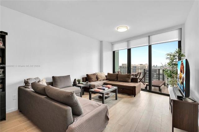 living room with light hardwood / wood-style flooring and a wall of windows