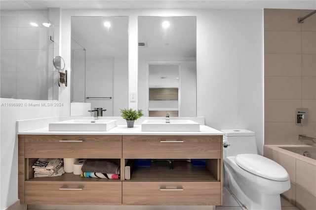 full bathroom featuring tile patterned flooring, vanity, toilet, and tiled shower / bath