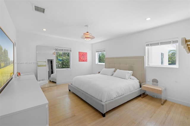 bedroom featuring ceiling fan and light hardwood / wood-style flooring