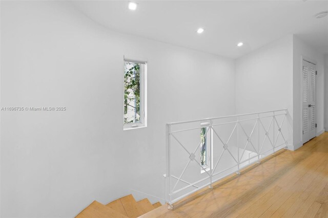 hallway with hardwood / wood-style floors