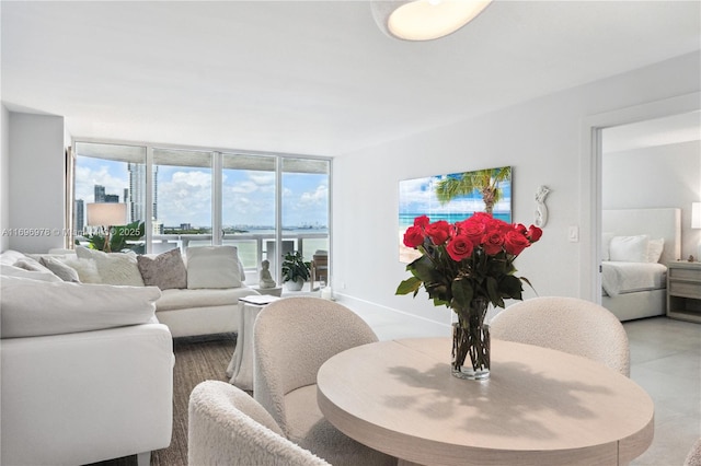 living room featuring a water view and expansive windows