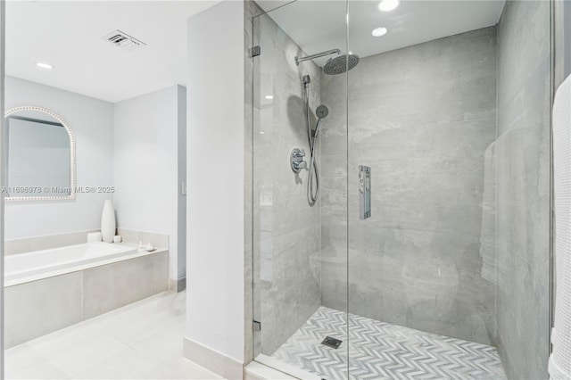 bathroom featuring separate shower and tub