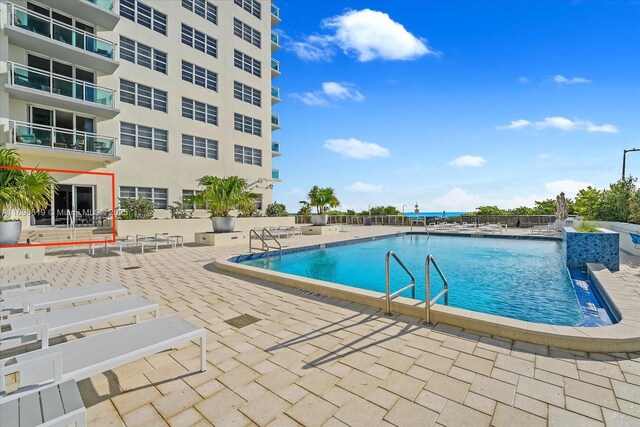 community pool with a patio area