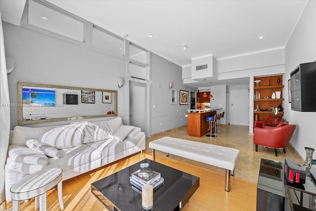 living room with built in shelves and crown molding