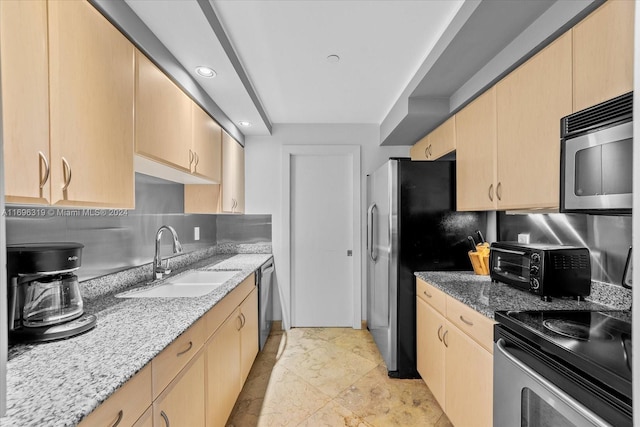 kitchen featuring backsplash, light brown cabinets, sink, and appliances with stainless steel finishes