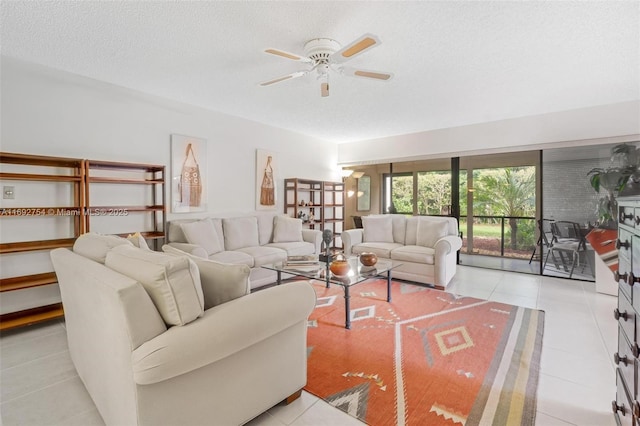 living room featuring light tile patterned floors, a textured ceiling, and ceiling fan