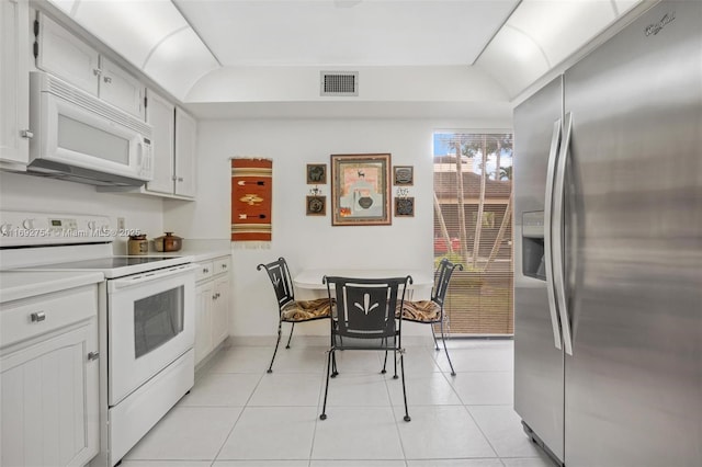 kitchen with white cabinets, white appliances, and light tile patterned floors