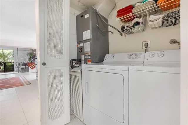 washroom featuring separate washer and dryer and light tile patterned flooring