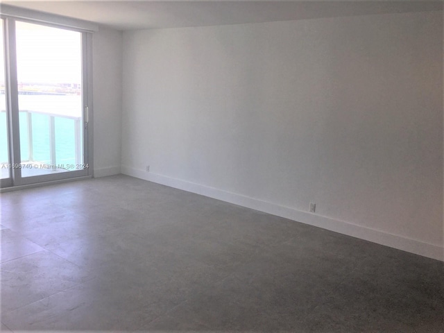 unfurnished room with a water view