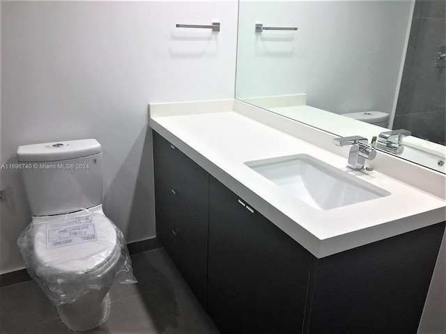 bathroom featuring tile patterned floors, vanity, and toilet