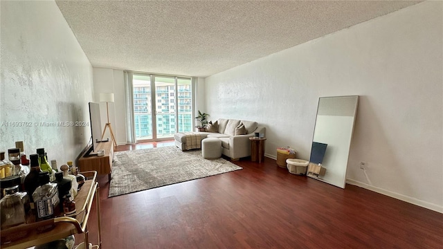 living room with a textured ceiling and dark hardwood / wood-style floors