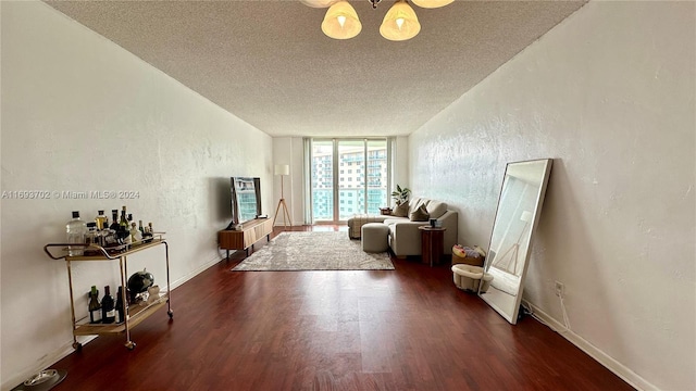 living room with dark hardwood / wood-style floors and a textured ceiling