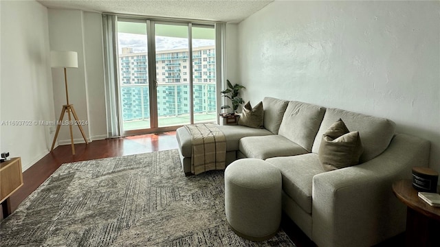 living room featuring floor to ceiling windows, dark wood-type flooring, and a textured ceiling