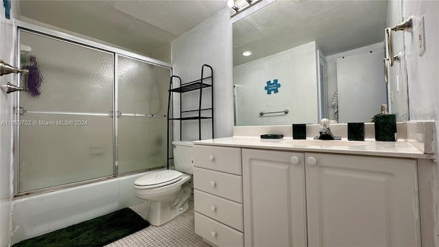 full bathroom with tile patterned flooring, vanity, toilet, and shower / bath combination with glass door