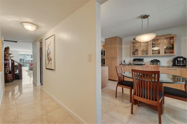 dining space featuring light tile patterned floors