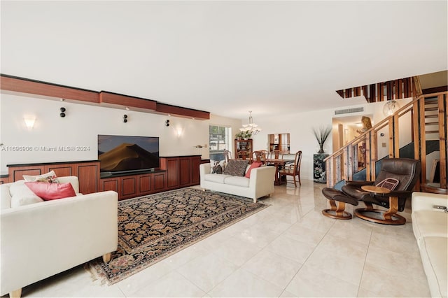 tiled living room featuring an inviting chandelier