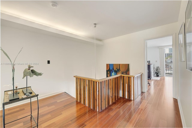 corridor with hardwood / wood-style flooring