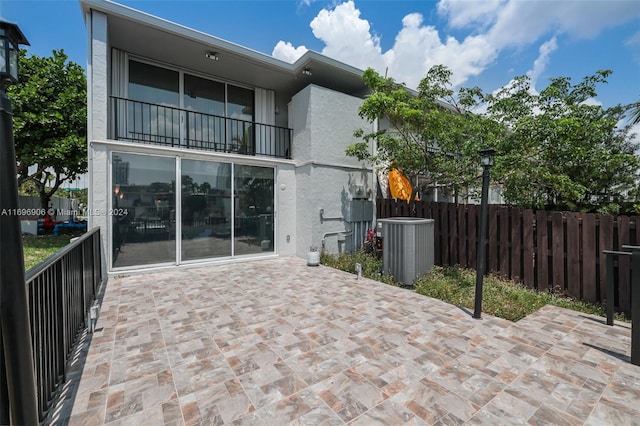 back of house featuring cooling unit and a patio area