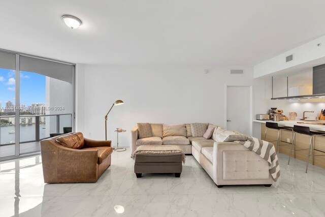 17301 Biscayne Blvd Unit 1404, North Miami, FL 33160 - living room with expansive windows, light marble finish floors, and a city view