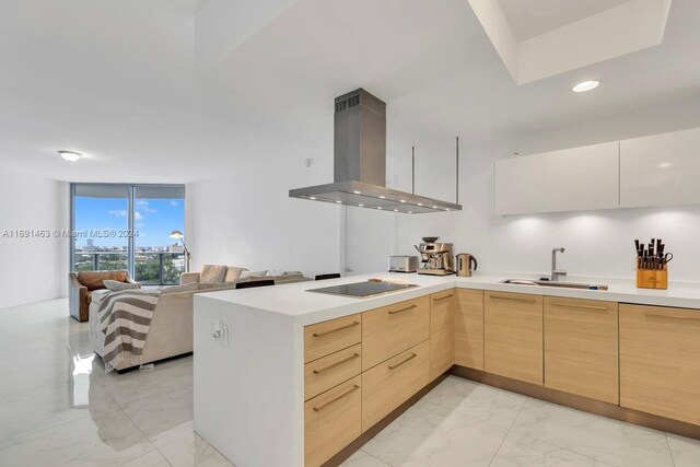 17301 Biscayne Blvd Unit 1404, North Miami, FL 33160 - kitchen featuring island range hood, modern cabinets, black electric cooktop, light marble finish flooring, and recessed lighting