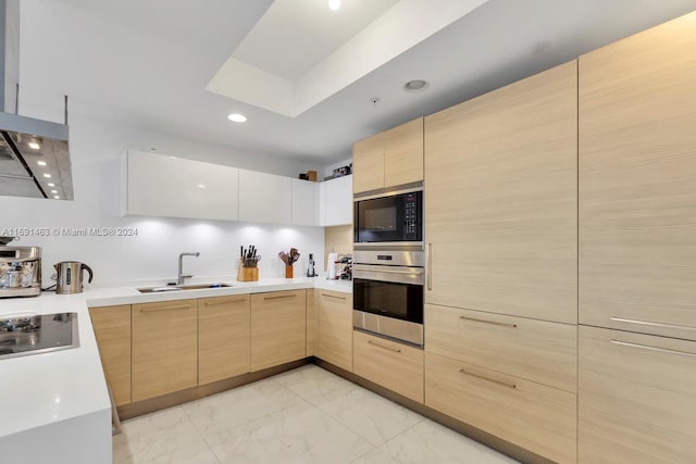 17301 Biscayne Blvd Unit 1404, North Miami, FL 33160 - kitchen with black appliances, light brown cabinetry, a sink, light marble finish floors, and light countertops
