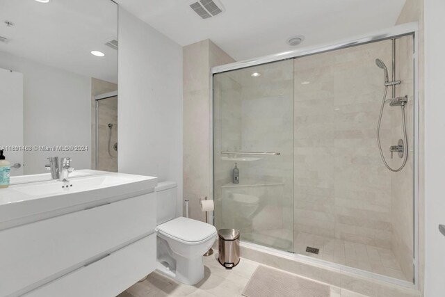 17301 Biscayne Blvd Unit 1404, North Miami, FL 33160 - bathroom featuring toilet, a stall shower, vanity, and recessed lighting