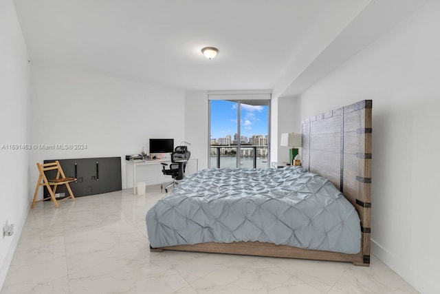 17301 Biscayne Blvd Unit 1404, North Miami, FL 33160 - bedroom featuring marble look tiles, a desk, and baseboards