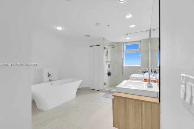 17301 Biscayne Blvd Unit 1404, North Miami, FL 33160 - full bathroom featuring a shower stall, double vanity, a freestanding bath, tile patterned flooring, and recessed lighting