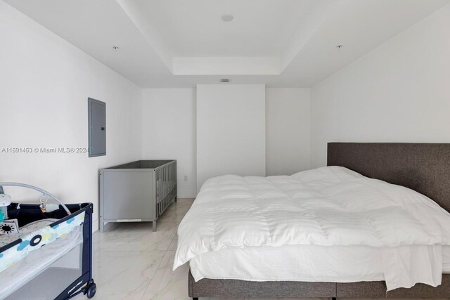 17301 Biscayne Blvd Unit 1404, North Miami, FL 33160 - bedroom with electric panel, a raised ceiling, and light marble finish flooring