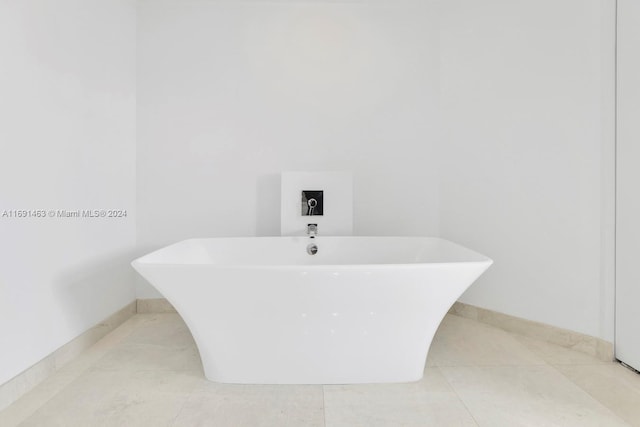 17301 Biscayne Blvd Unit 1404, North Miami, FL 33160 - bathroom featuring a soaking tub, tile patterned floors, and baseboards
