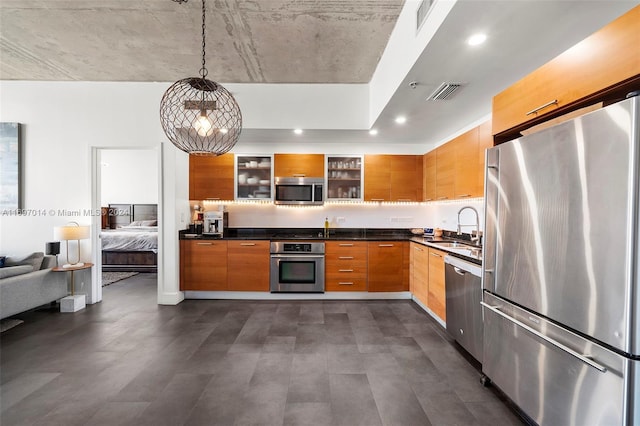 kitchen with sink, hanging light fixtures, dark hardwood / wood-style floors, and appliances with stainless steel finishes