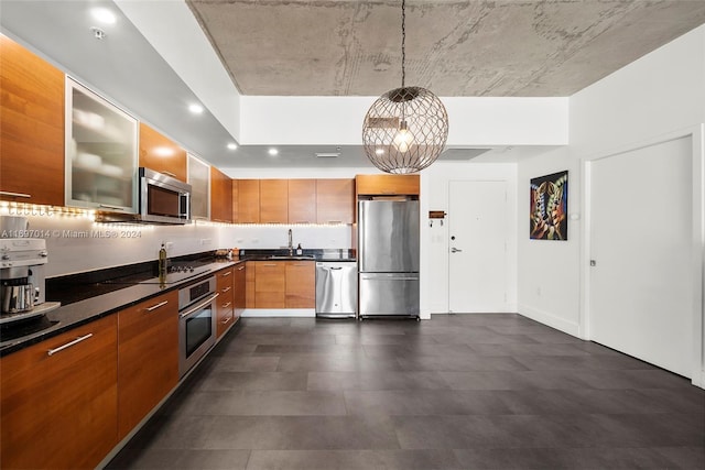 kitchen with pendant lighting, stainless steel appliances, and sink