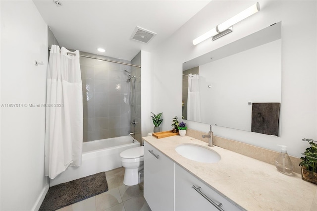 full bathroom featuring tile patterned flooring, vanity, toilet, and shower / bath combo with shower curtain