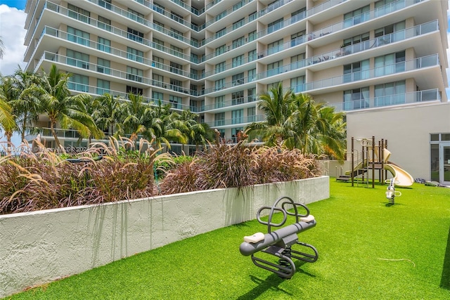 view of property's community featuring a playground and a yard