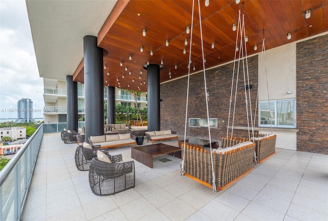 view of patio featuring an outdoor living space and a balcony