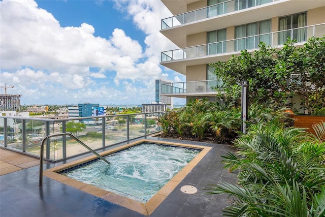 view of swimming pool with a hot tub