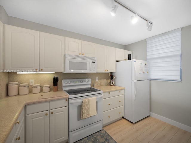 kitchen with white cabinetry, track lighting, light hardwood / wood-style floors, and white appliances