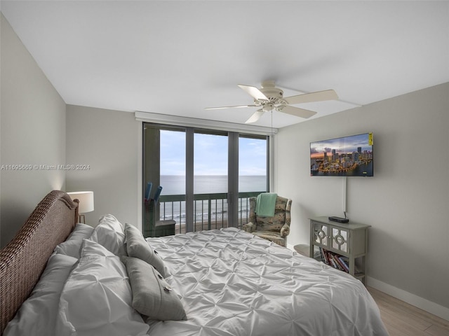 bedroom with ceiling fan, access to exterior, and wood-type flooring