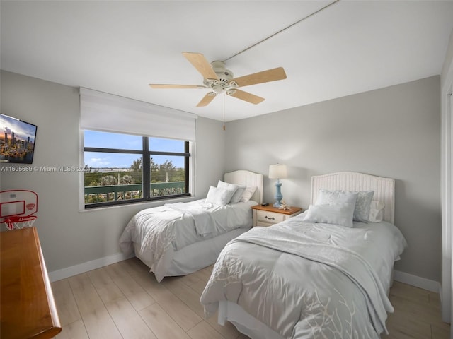 bedroom with ceiling fan and light wood-type flooring