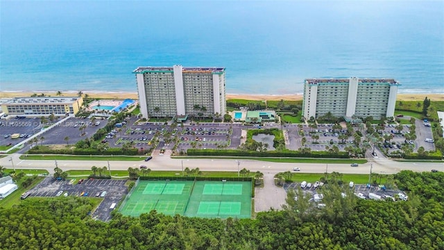 birds eye view of property with a water view and a view of the beach